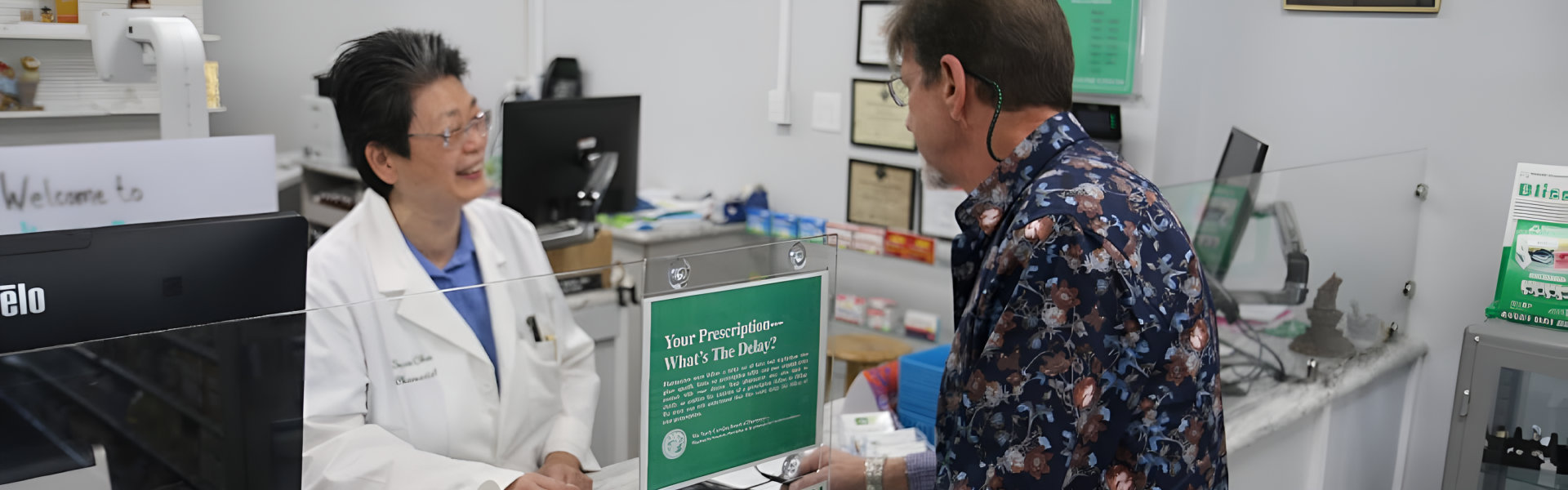 A pharmacist assists a patient at the pharmacy counter