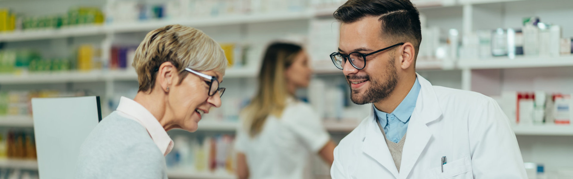 male pharmacist giving prescription medications